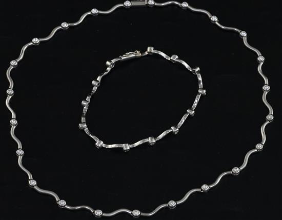 An 18ct white gold and diamond set spectacle necklace and matching bracelet, necklace approx. 40cm.